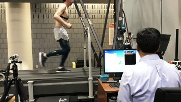 Ajit Chaudhari, PhD, FACSM, monitors a runner using motion sensor technology to study the effects of compression tights on muscle vibration and fatigue.