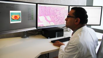 Dr. Anil Parwani views a digital pathology slide at The Ohio State University Comprehensive Cancer Center - Arthur G. James Cancer Hospital and Richard J. Solove Research Institute. This advanced technology helps to provide patients with faster and more accurate diagnoses.