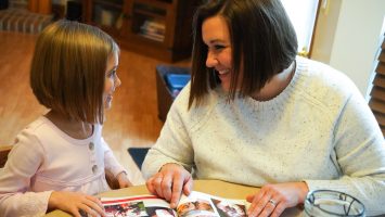 Kara Schooley reads with her 5-year-old daughter, Parker. Kara was closely monitored during both of her pregnancies because of the risks high blood pressure posed to her heart.