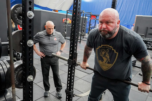 Physical therapist Chris Kolba instructs Police Sgt. Joseph Riddle on a drill that mimics climbing over a fence. By replicating scenarios that first responders commonly face, a new program at The Ohio State University Wexner Medical Center is helping them physically and mentally prepare for the demands of their jobs.